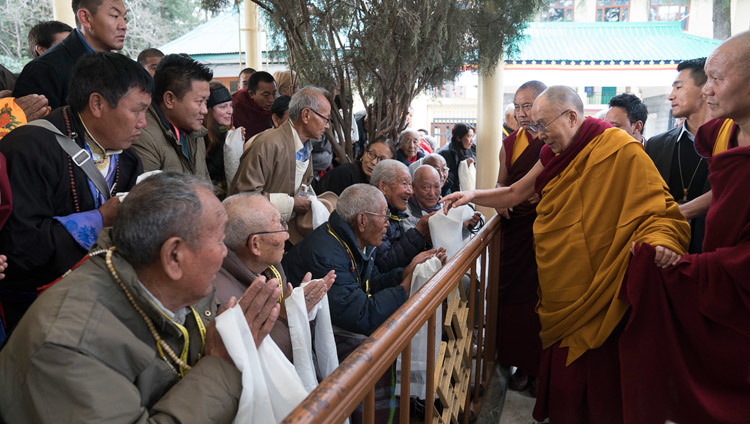 His Holiness the Dalai Lama greeting members of the crowd gathered in the courtyard as he makes his way to the Main Tibetan Temple for the first day of his two day teaching in Dharamsala, HP, India on March 13, 2017. Photo by Tenzin Choejor/OHHDL