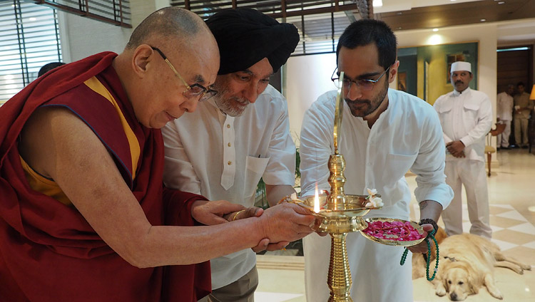 His Holiness the Dalai Lama along with Analjit Singh and his son Vir lighting a lamp to inaugurate the meeting with the Core Committee Working on the Curriculum for Universal Values in New Delhi, India on April 28, 2017. Photo by Jeremy Russell/OHHDL