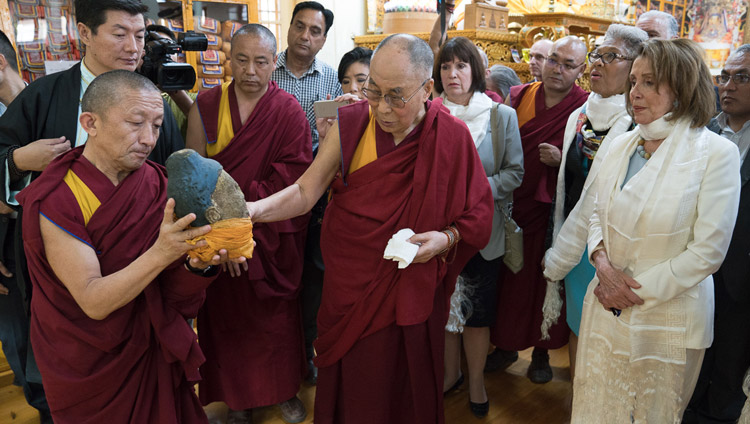 His Holiness the Dalai Lama showing members of the bipartisan US Congressional Delegation part of a statue destroyed in Tibet during the Cultural Revolution as he guides them round the Main Tibetan Temple Dharamsala, HP, India on May 10, 2017. Photo by Tenzin Choejor/OHHDL